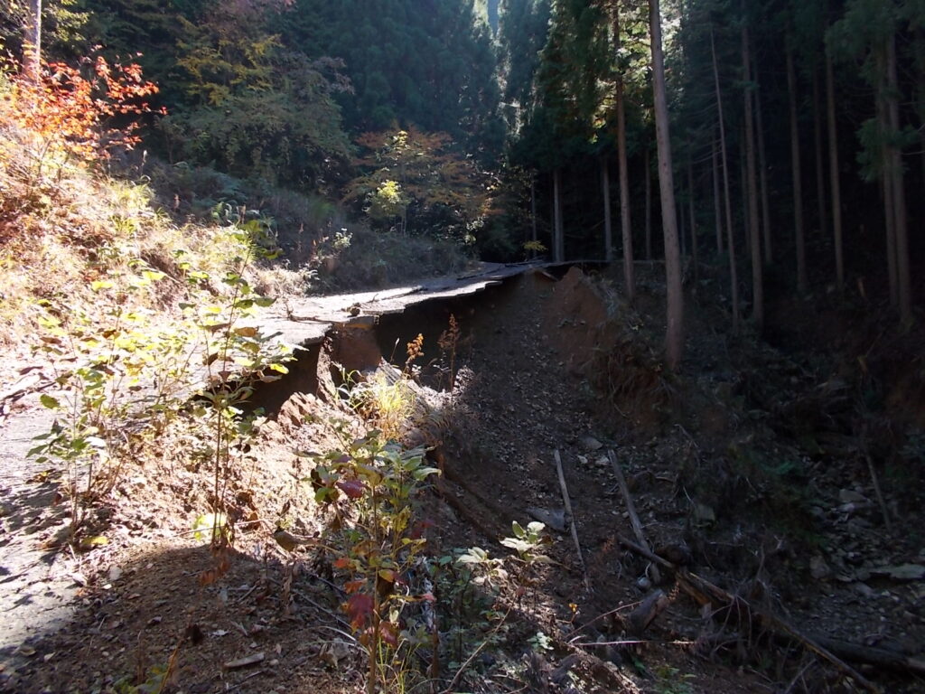 12:31 崩落地。雨でアスファルトの下の土がすべて流されてしまってます。アスファルトは通らずに山側の土の上を歩きます。