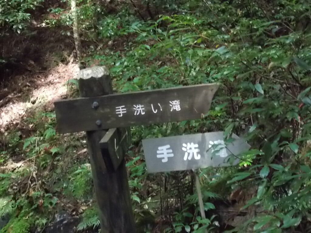 9：56　手洗いの滝の案内板。